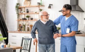 medical-worker-helping-his-patient-to-move-around-the-apartment