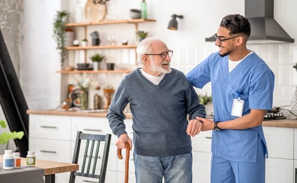 medical-worker-helping-his-patient-to-move-around-the-apartment